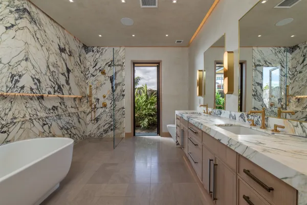 a bathroom with a double vanity sink and a mirror
