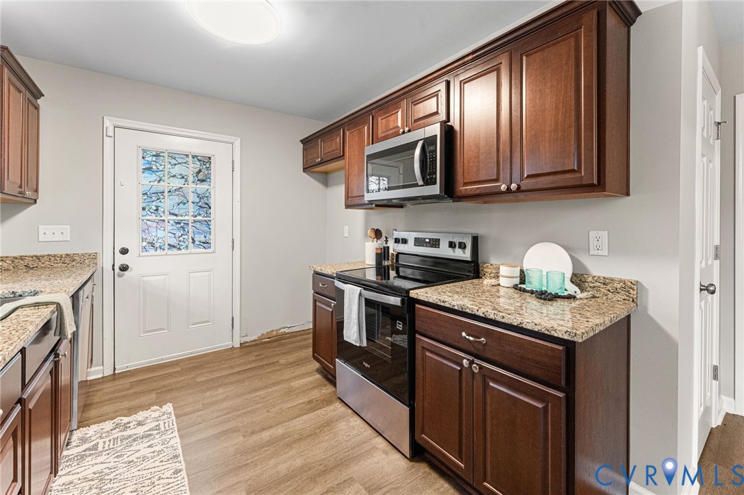 829 Rome Street Petersburg, VA 23803 - Photo 7 of 22 a kitchen with stainless steel appliances granite countertop a stove a sink and a microwave