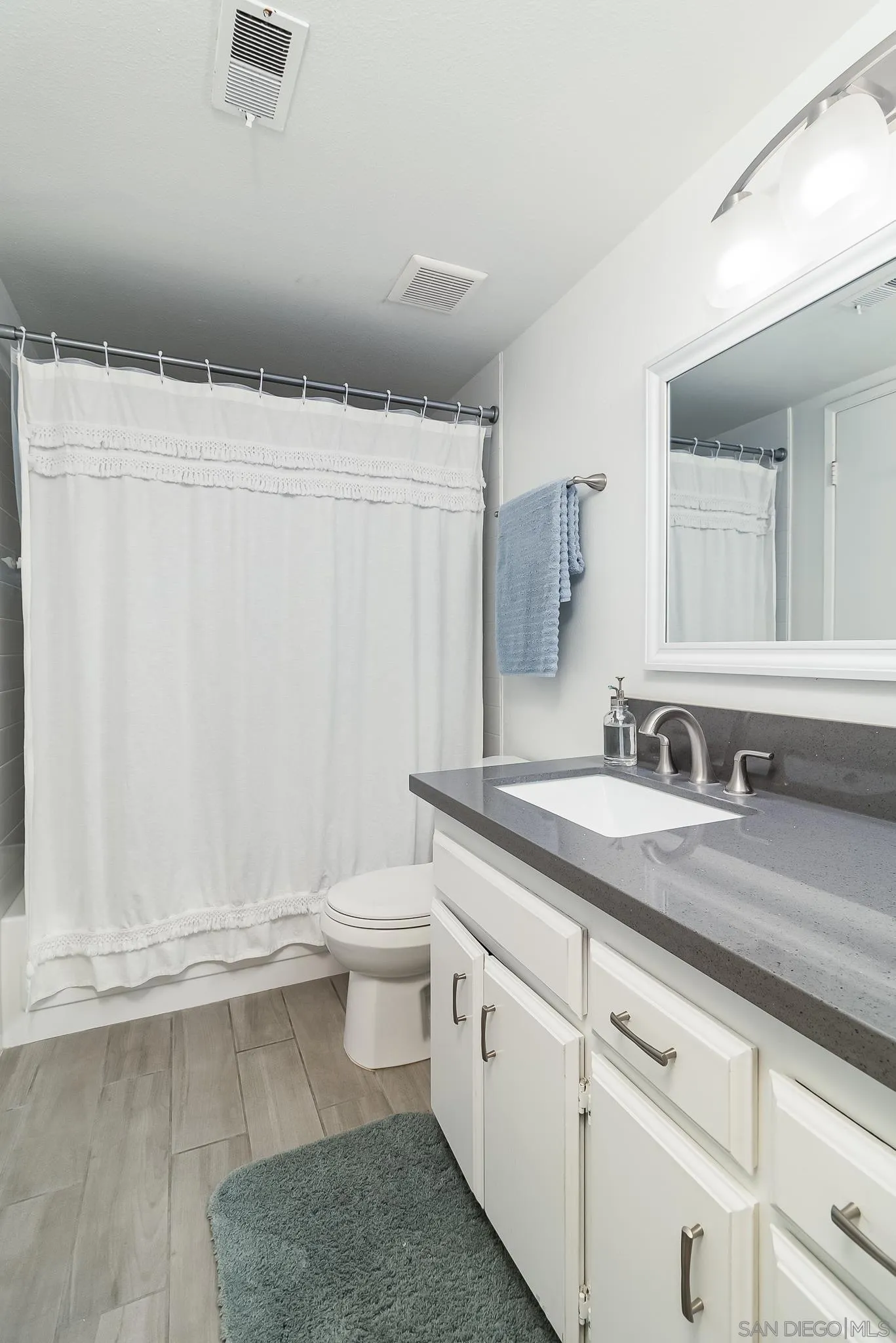 350 G Street, Unit E2 Chula Vista, CA 91910 - Photo 12 of 30 a bathroom with a granite countertop sink and a mirror