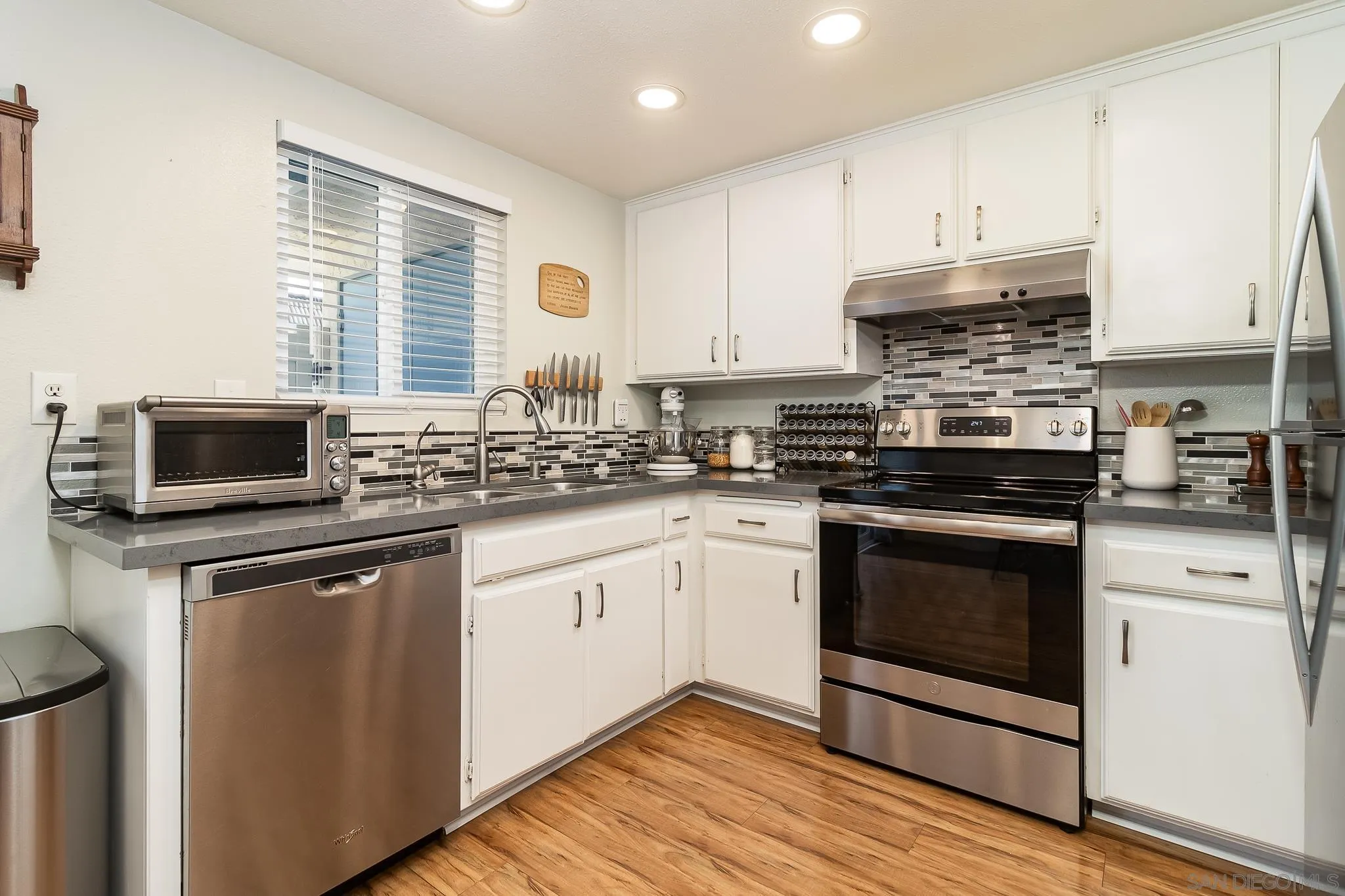 350 G Street, Unit E2 Chula Vista, CA 91910 - Photo 7 of 30 a kitchen with stainless steel appliances granite countertop a stove a sink and a microwave
