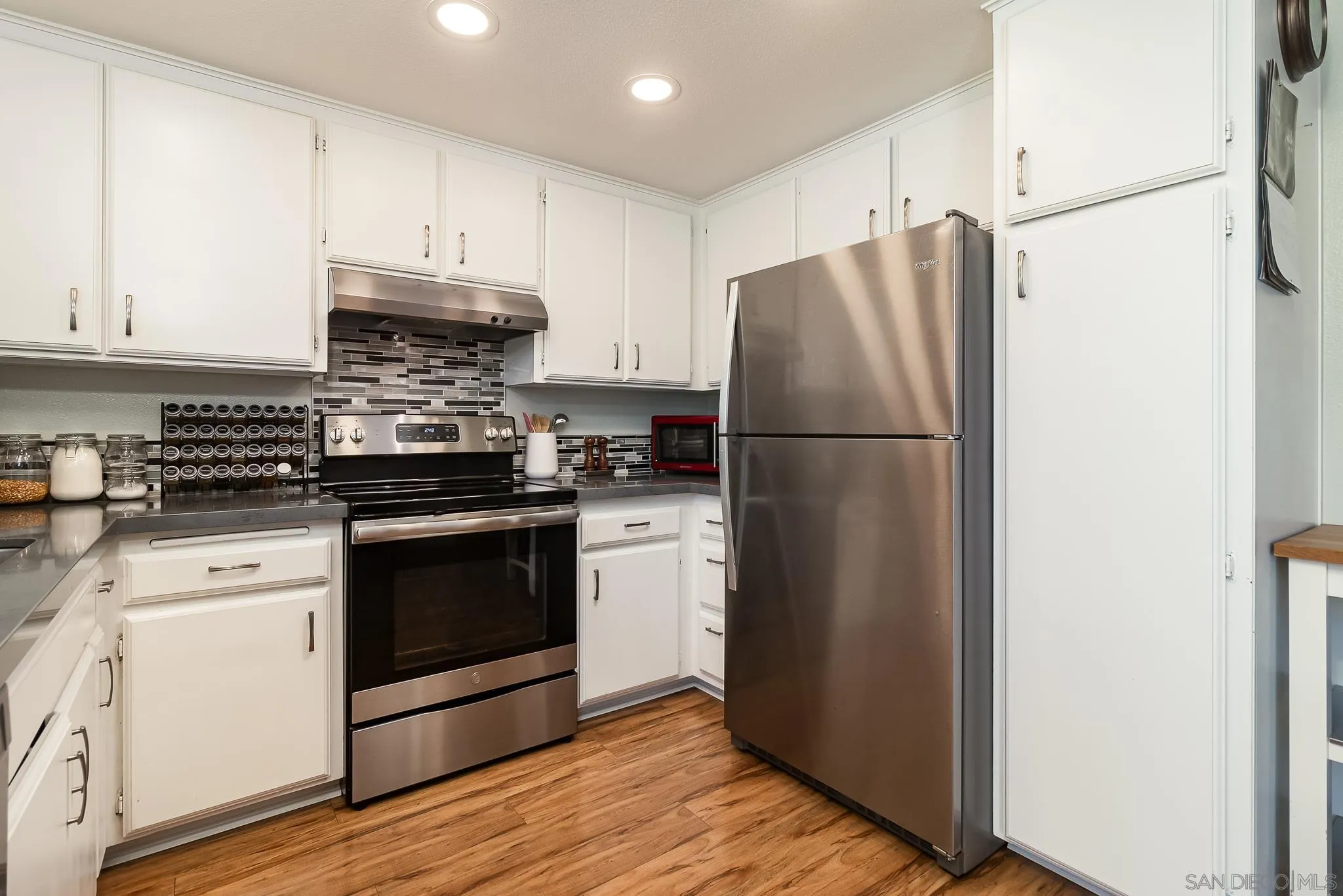 350 G Street, Unit E2 Chula Vista, CA 91910 - Photo 8 of 30 a kitchen with a refrigerator stove and white cabinets