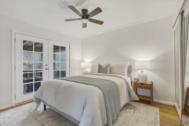 a spacious bedroom with a bed and a large window