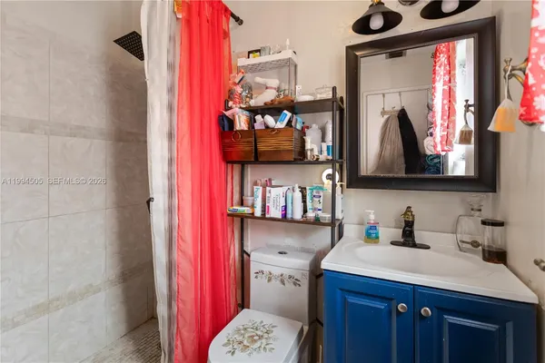 a bathroom with a sink vanity and mirror