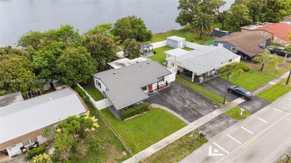an aerial view of a house with garden space and street view
