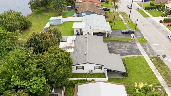 an aerial view of a house with a garden and swimming pool