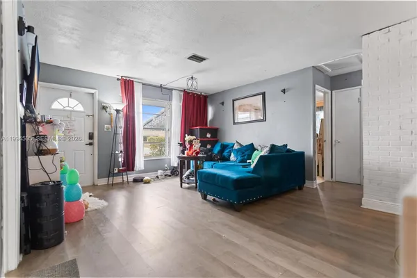 a living room with furniture window and wooden floor