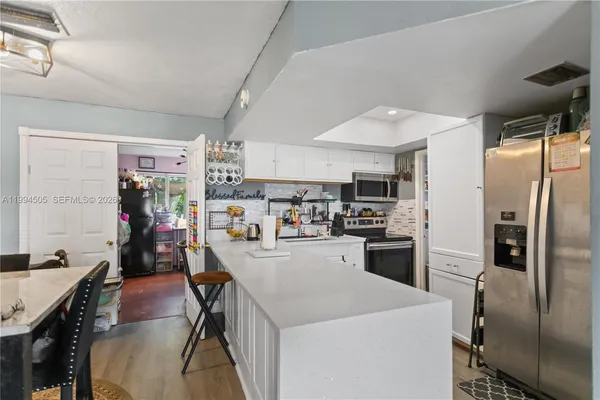 a kitchen with refrigerator and cabinets