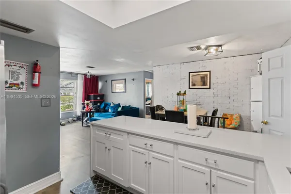 a kitchen with sink cabinets and living room view