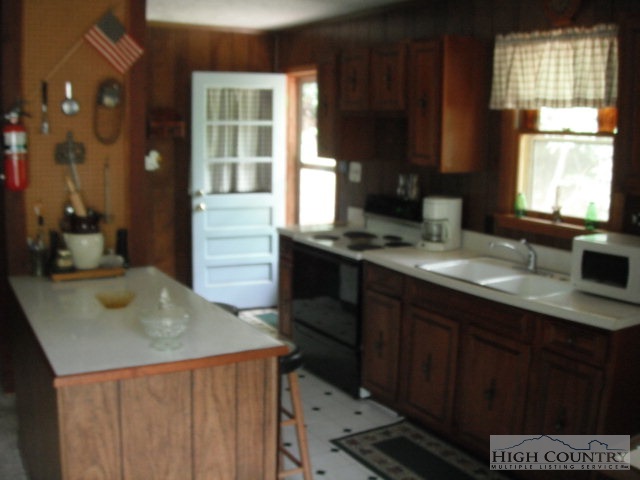 512 Rainbow Mountain Road Boone, NC 28607 - Photo 2 of 4 a kitchen with a sink a window and cabinets