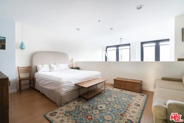 a bedroom with a bed and a couch