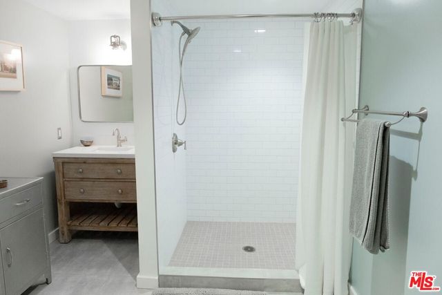 a bathroom with a shower and a sink