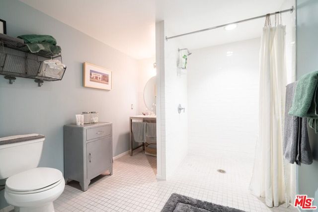 a bathroom with a shower a toilet and a shower