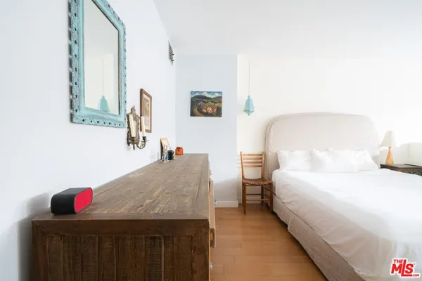 a bedroom with a bed and a dresser