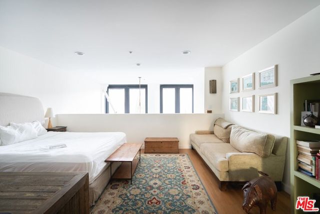 a bedroom with a bed and a couch