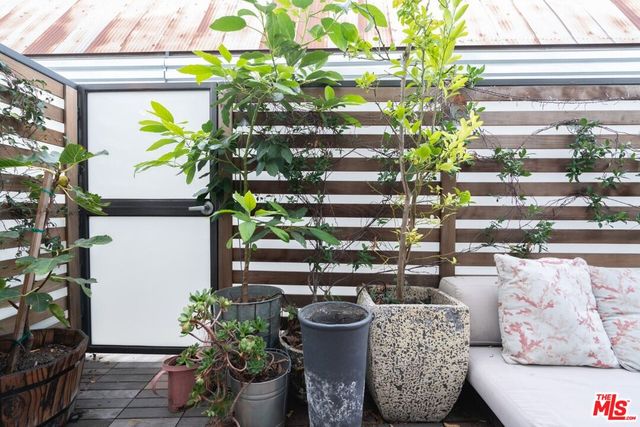 a vase of flowers sitting on a table in front of a window