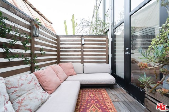 a view of balcony with couch and wooden floor