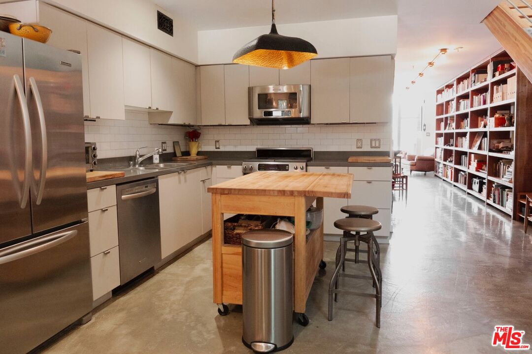 700 Main Street, Unit 12 Venice, CA 90291 - Photo 4 of 27 a kitchen with stainless steel appliances granite countertop a stove a sink and a refrigerator