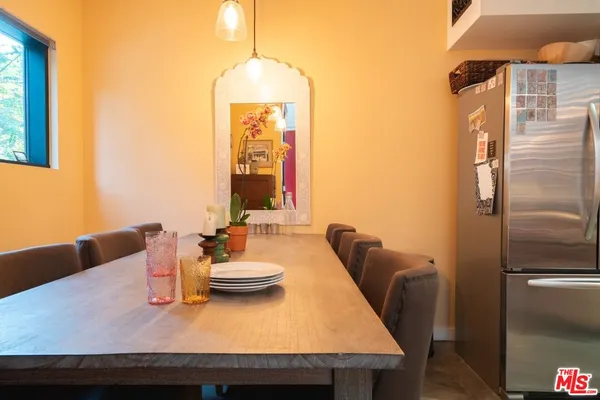 a dining room with furniture and a chandelier