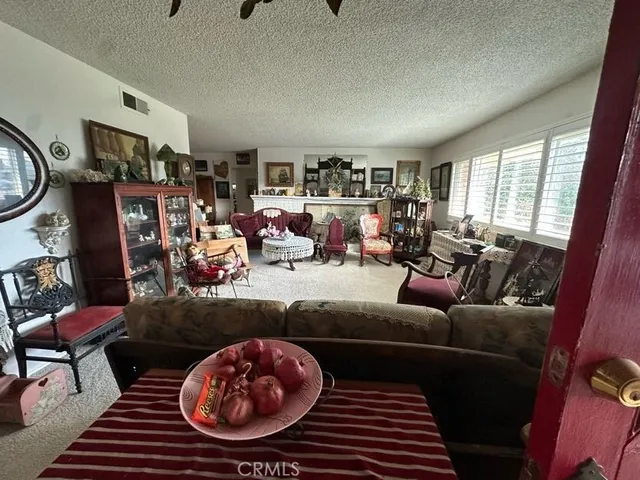 a living room with furniture a rug and a window