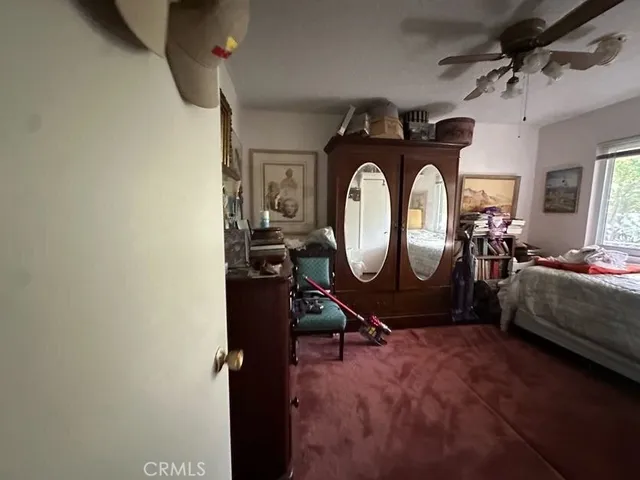 a living room with furniture and a mirror