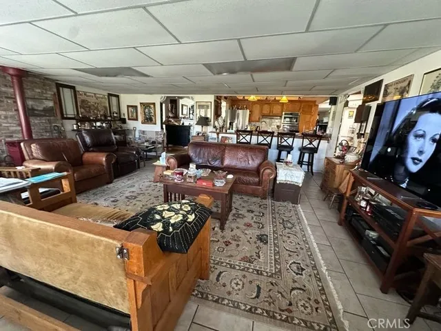 a living room with lots of furniture and clutter