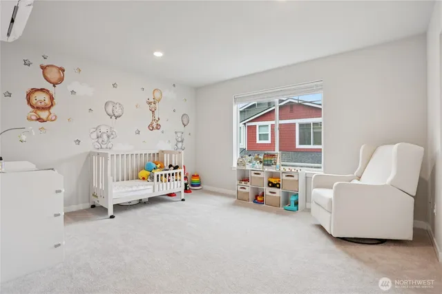 a bedroom with baby crib and dresser