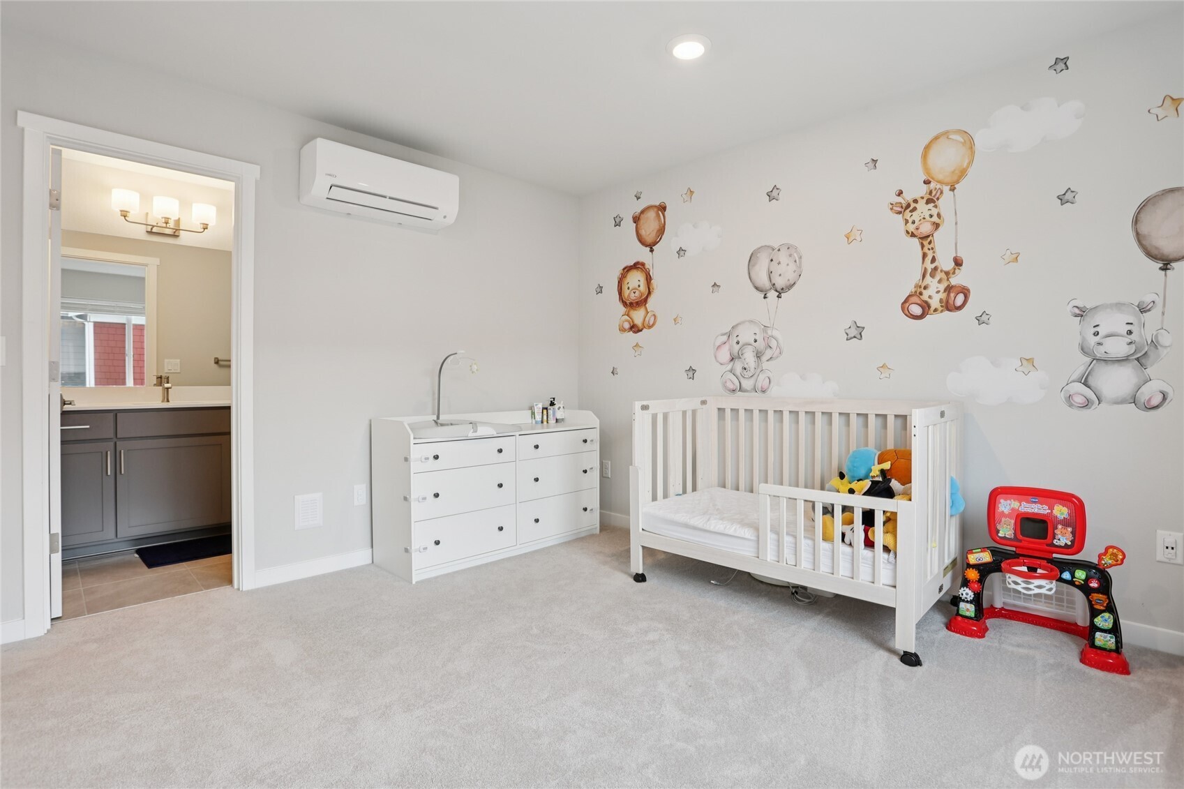 12006 Northeast 194th Drive, Unit E Bothell, WA 98011 - Photo 15 of 25 a bedroom with baby crib and dresser