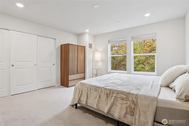 a spacious bedroom with a bed and a window