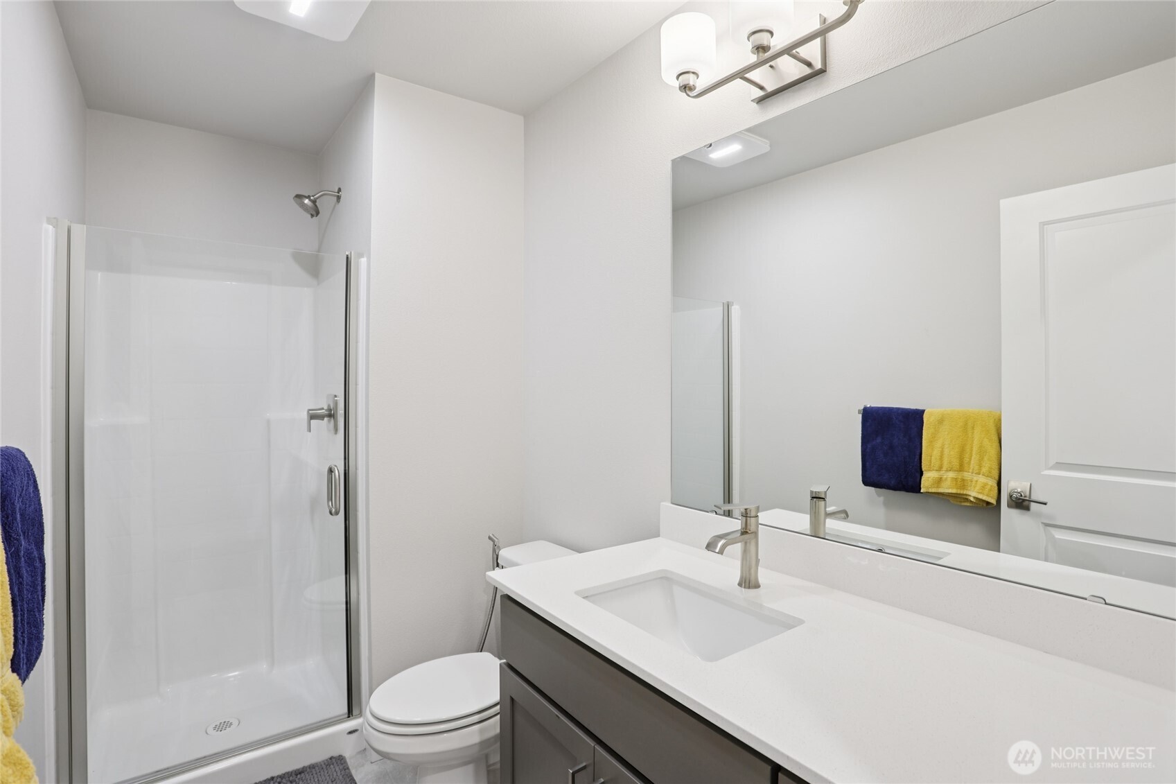 12006 Northeast 194th Drive, Unit E Bothell, WA 98011 - Photo 24 of 25 a bathroom with a sink toilet and shower