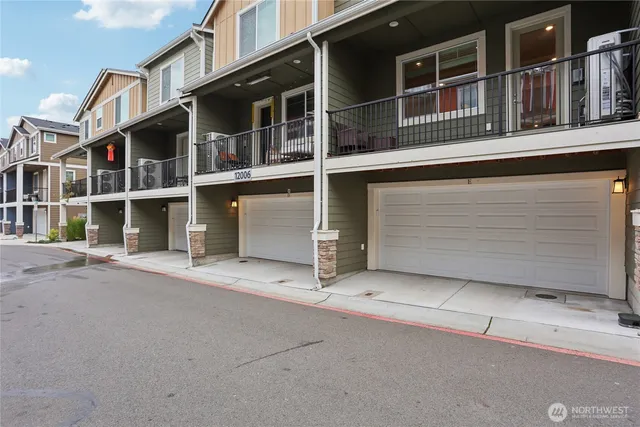 a kitchen with a stove a sink a center island and windows