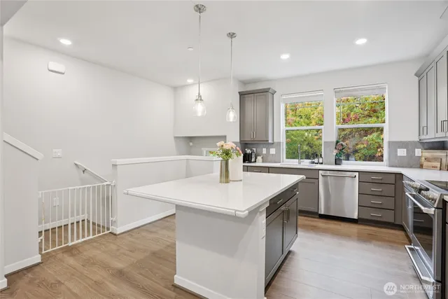a kitchen with a sink a stove and refrigerator