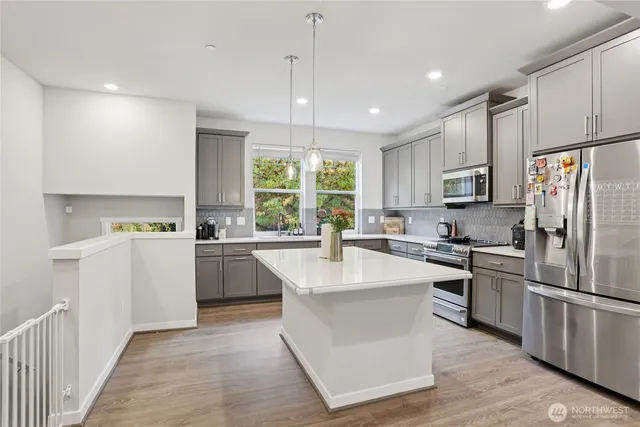 a view of a dining room with furniture wooden floor and a kitchen