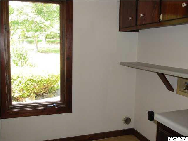 264 Creek Road Troy, VA 22974 - Photo 27 of 39 First level laundry room with washer/dryer hookup, cabinets & folding table.