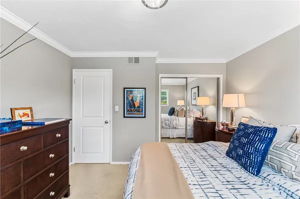 a bedroom with furniture and a dresser