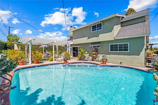 a view of a house with swimming pool and porch with furniture