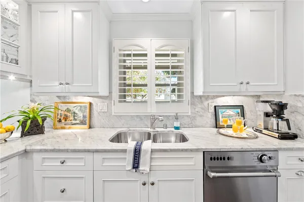 a kitchen with appliances cabinets and a window