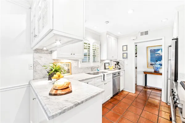a kitchen with a sink appliances and cabinets