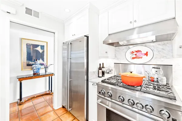a kitchen with a stove and a refrigerator