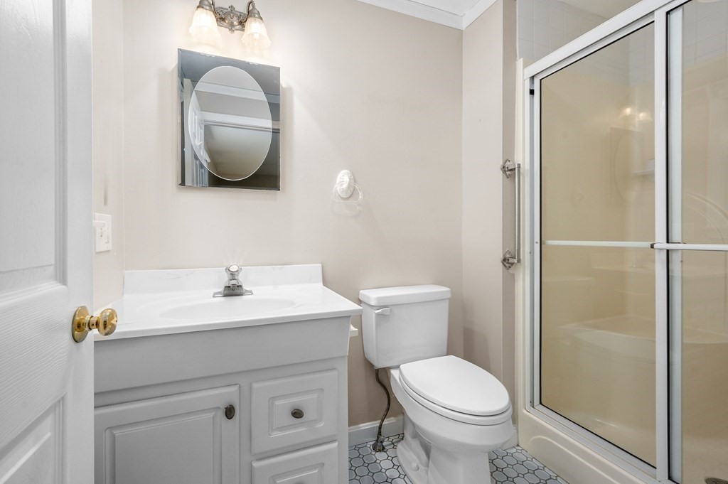 21 Micah Hamlin Road Centerville, MA 02632 - Photo 18 of 42 a bathroom with a toilet a sink and mirror