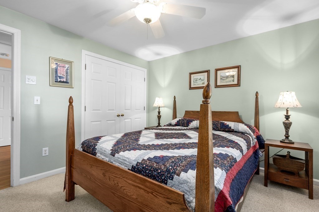 21 Micah Hamlin Road Centerville, MA 02632 - Photo 20 of 42 a bedroom with a bed and a lamp