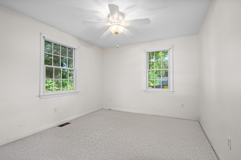 21 Micah Hamlin Road Centerville, MA 02632 - Photo 21 of 42 an empty room with a window and a ceiling fan
