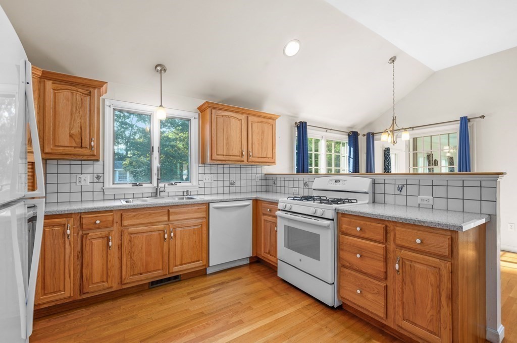 21 Micah Hamlin Road Centerville, MA 02632 - Photo 8 of 42 a kitchen with stainless steel appliances granite countertop stove a sink dishwasher a refrigerator and cabinets with wooden floor