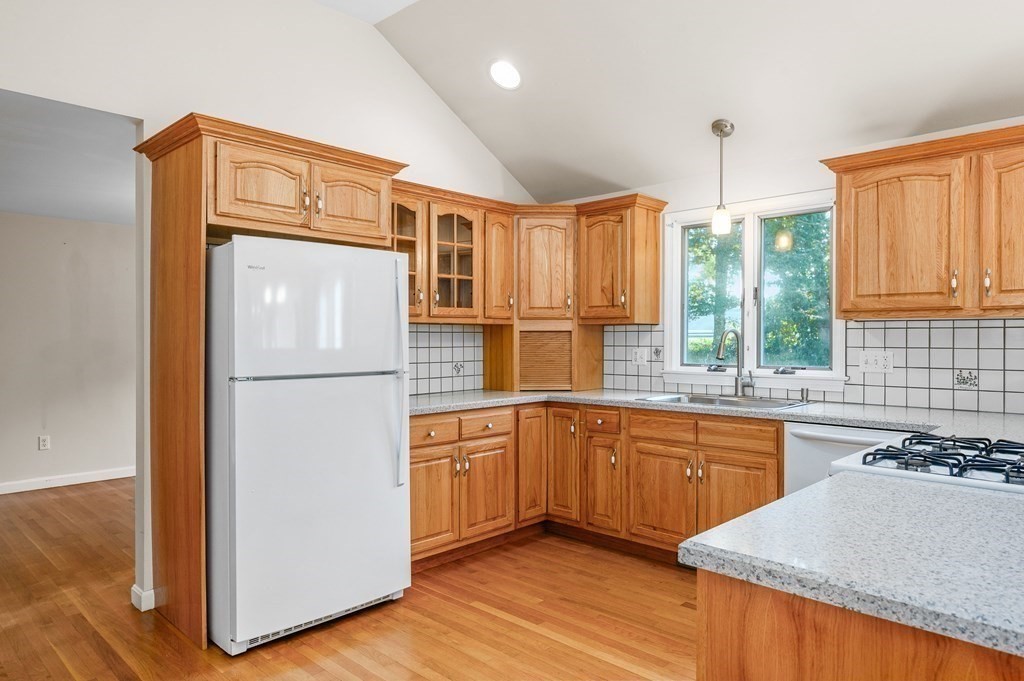 21 Micah Hamlin Road Centerville, MA 02632 - Photo 9 of 42 a kitchen with stainless steel appliances granite countertop a sink stove and refrigerator