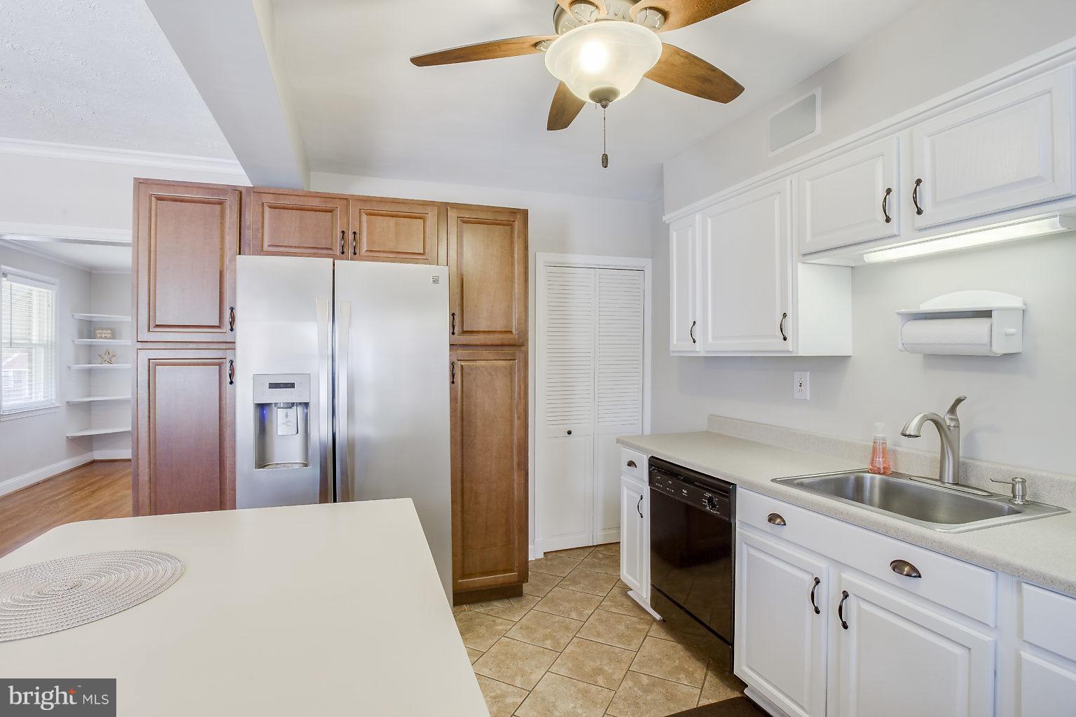 8626 Oak Road Baltimore, MD 21234 - Photo 12 of 30 a kitchen with stainless steel appliances a refrigerator sink and white cabinets