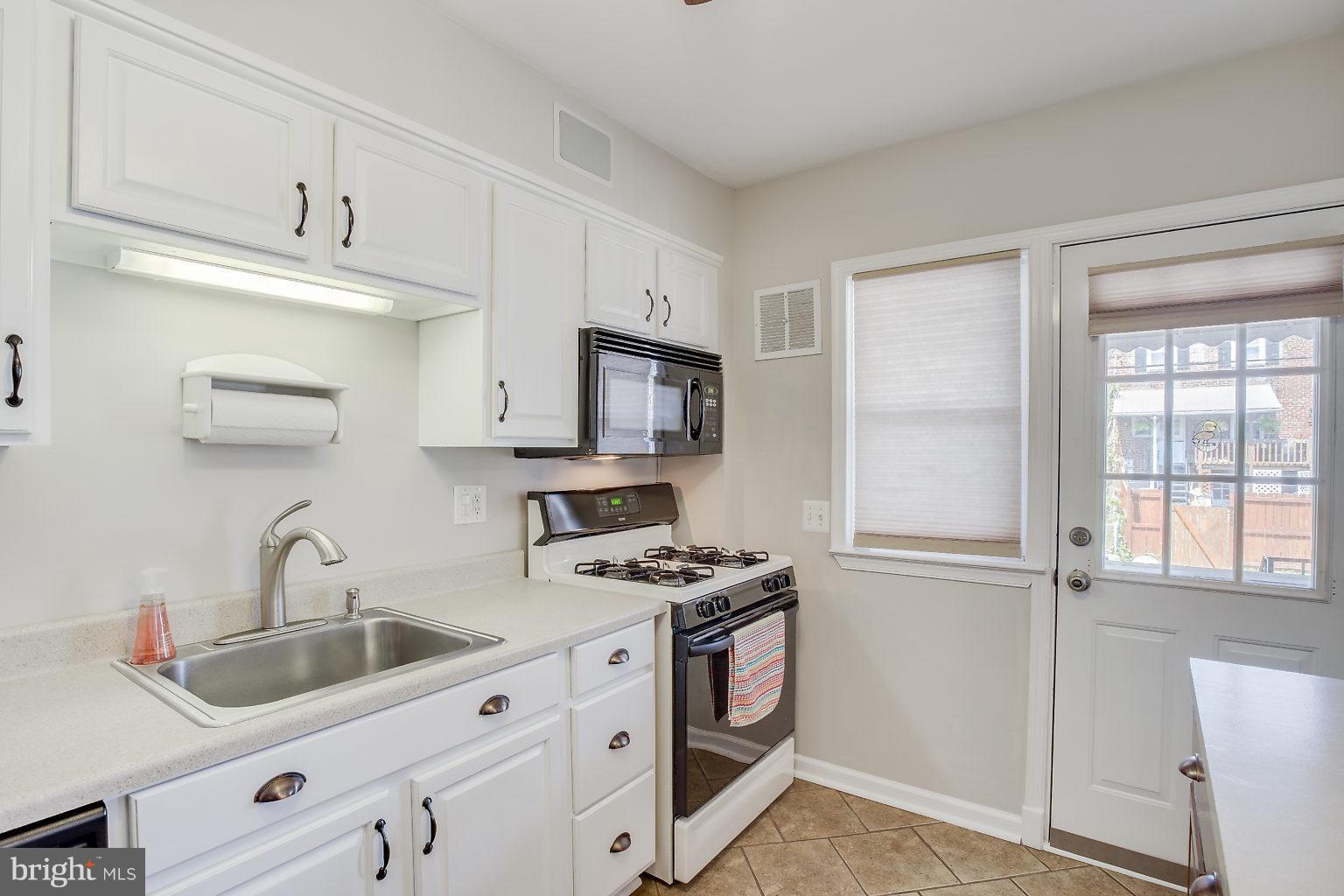 8626 Oak Road Baltimore, MD 21234 - Photo 15 of 30 a kitchen with appliances a sink and cabinets