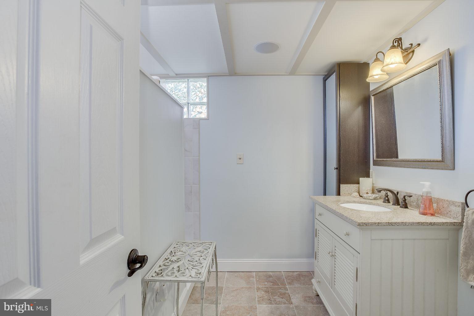 8626 Oak Road Baltimore, MD 21234 - Photo 18 of 30 a bathroom with a sink vanity and a mirror