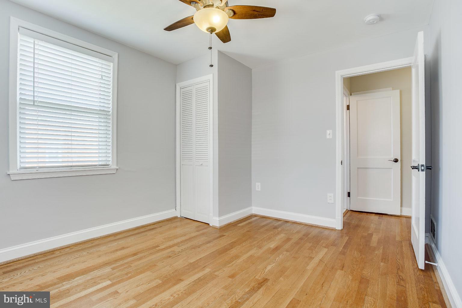 8626 Oak Road Baltimore, MD 21234 - Photo 25 of 30 a view of empty room with wooden floor and fan