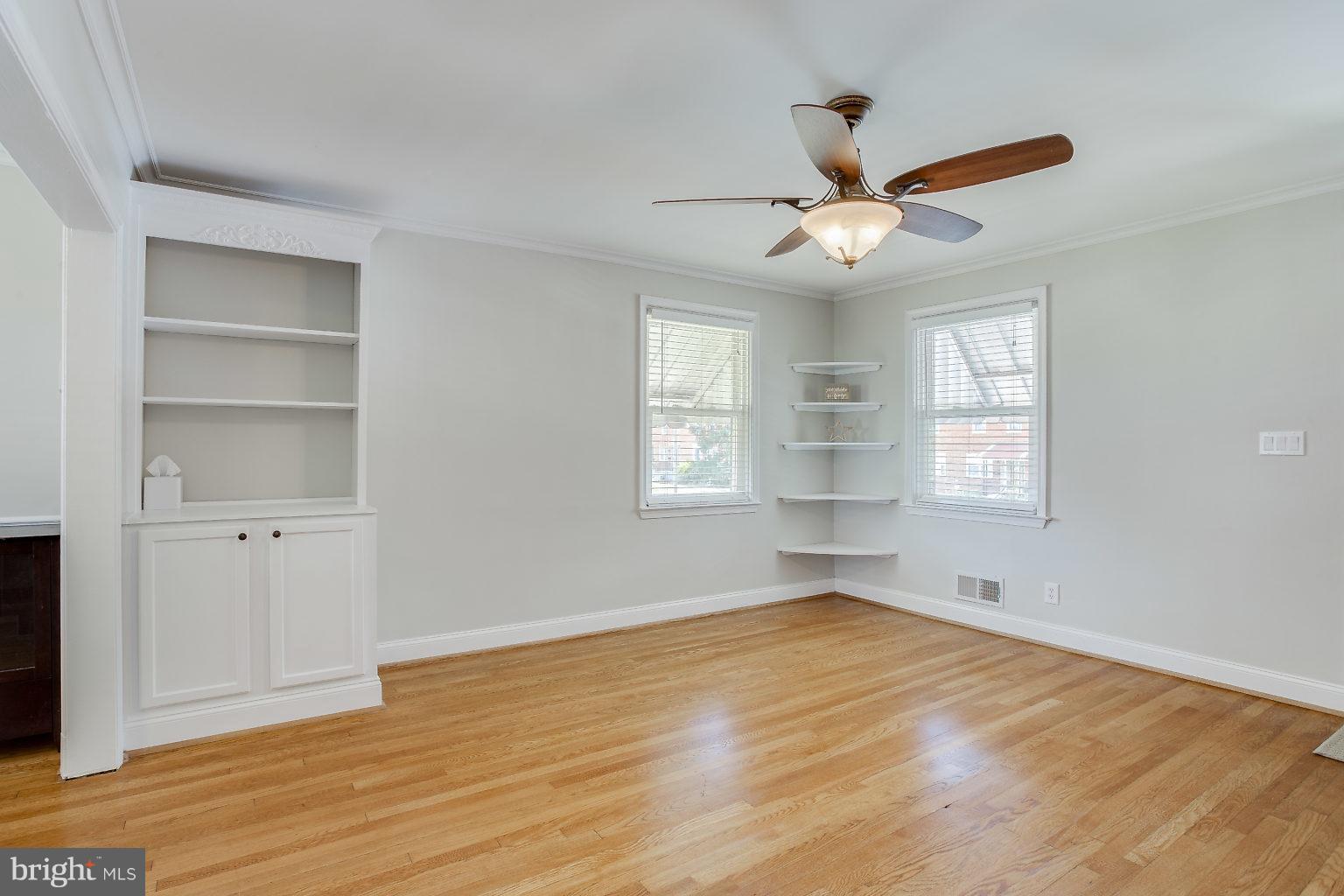 8626 Oak Road Baltimore, MD 21234 - Photo 8 of 30 a view of an empty room with a window and wooden floor