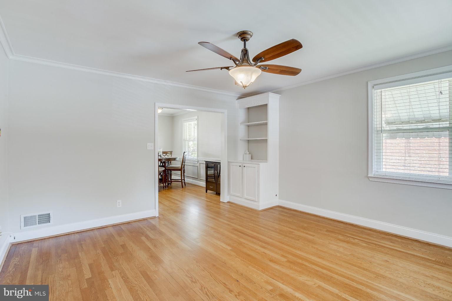 8626 Oak Road Baltimore, MD 21234 - Photo 9 of 30 a view of a livingroom with wooden floor and a ceiling fan