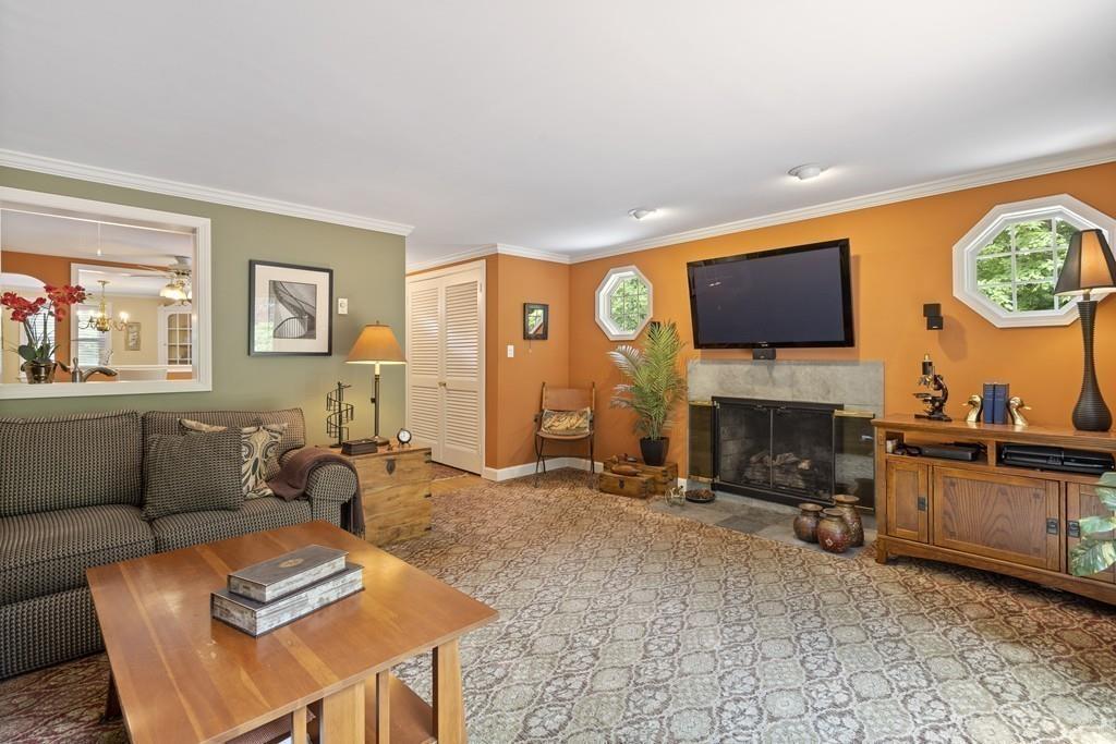 56 Ledgewood Road Dedham, MA 02026 - Photo 16 of 36 a living room with furniture a flat screen tv and a fireplace